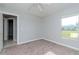 Bright bedroom features neutral carpet, a ceiling fan, and a window that provides natural light at 3206 Duchess Ct, Plant City, FL 33565