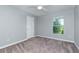 Neutral bedroom with carpet, ceiling fan, and window with green outdoor view at 3206 Duchess Ct, Plant City, FL 33565