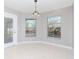 Cozy dining area with tile floors, large windows, and sliding door access to the lanai at 3206 Duchess Ct, Plant City, FL 33565