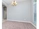 Open dining room with neutral carpet and a chandelier, ready for entertaining at 3206 Duchess Ct, Plant City, FL 33565