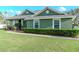 Charming green home with a well-maintained lawn and mature landscaping at 3206 Duchess Ct, Plant City, FL 33565