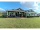 Charming single-story green home with manicured lawn and stone accents at 3206 Duchess Ct, Plant City, FL 33565