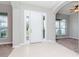 Bright foyer with tile flooring, a white front door, and arched doorways at 3206 Duchess Ct, Plant City, FL 33565