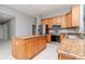 Modern kitchen featuring granite countertops, stainless steel appliances, and a central island at 3206 Duchess Ct, Plant City, FL 33565