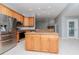 Open kitchen layout featuring stainless appliances and a granite-topped island at 3206 Duchess Ct, Plant City, FL 33565