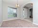 Inviting living room features neutral tones, a large window, and an elegant chandelier at 3206 Duchess Ct, Plant City, FL 33565