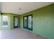 View of the covered patio area with windows and double doors leading to the backyard at 3206 Duchess Ct, Plant City, FL 33565