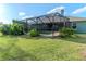 Outdoor screened-in pool area with lush landscaping surrounding the fenced in pool at 3206 Duchess Ct, Plant City, FL 33565