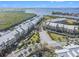 Waterfront condo complex surrounded by lush landscape and the adjacent beach at 3266 Mangrove Point Dr, Ruskin, FL 33570