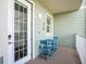 Cozy balcony with seating area, white railing, and door to the interior at 3266 Mangrove Point Dr, Ruskin, FL 33570