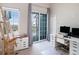 Bright bedroom featuring a large sliding door, a computer desk and chair, and an art easel for creative expression at 3266 Mangrove Point Dr, Ruskin, FL 33570