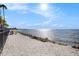 Community beach area with colorful Adirondack chairs, a shell beach, and an ocean view at 3266 Mangrove Point Dr, Ruskin, FL 33570