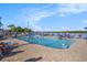 Outdoor community pool area with lounge chairs and a crowd of residents enjoying the sunshine at 3266 Mangrove Point Dr, Ruskin, FL 33570