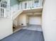 Attached garage of a three-story townhouse featuring pale green siding and white trim at 3266 Mangrove Point Dr, Ruskin, FL 33570