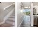 Hallway featuring a staircase and plank flooring that leads into an open concept living and dining area at 3266 Mangrove Point Dr, Ruskin, FL 33570