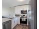 Bright kitchen with stainless steel appliances, white cabinetry, and quartz countertops at 3266 Mangrove Point Dr, Ruskin, FL 33570