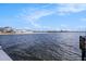 Scenic water view of the ocean with a sandy beach and buildings in the background at 3266 Mangrove Point Dr, Ruskin, FL 33570