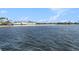 Scenic water view of the ocean with a sandy beach and buildings in the background at 3266 Mangrove Point Dr, Ruskin, FL 33570