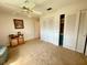 Neutral bedroom with a ceiling fan, closet space, and hardwood dresser at 3745 100Th N Pl # 3745, Pinellas Park, FL 33782