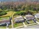 This aerial view showcases a single-Gathering home with a fenced backyard near a wooded area at 3934 Moog Rd, Holiday, FL 34691