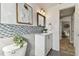 Stylish bathroom featuring a patterned backsplash, modern vanity, and decorative accents for a sophisticated look at 3934 Moog Rd, Holiday, FL 34691