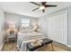 Bedroom showcasing a ceiling fan, wood floors, and inviting decor at 3934 Moog Rd, Holiday, FL 34691