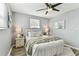 Serene bedroom featuring a ceiling fan, soft lighting and a comfortable bed at 3934 Moog Rd, Holiday, FL 34691