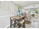 Cozy dining area with bar-stool seating, view of the living room at 3934 Moog Rd, Holiday, FL 34691