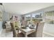 Bright dining room with a wooden table, wicker chairs, and natural light at 3934 Moog Rd, Holiday, FL 34691