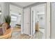 Hallway featuring modern decor, light gray walls, and hardwood flooring at 3934 Moog Rd, Holiday, FL 34691