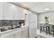 Modern kitchen featuring stainless sink, modern backsplash and stainless refrigerator at 3934 Moog Rd, Holiday, FL 34691