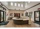 Bright lobby featuring a stone accent wall, high ceilings, wood-look flooring, and a modern reception desk at 9727 Minnow Ray Dr, Land O Lakes, FL 34638