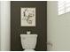 Stylish powder room with a modern toilet and decorative wall art at 9727 Minnow Ray Dr, Land O Lakes, FL 34638