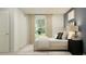 Cozy bedroom featuring a large window, soft lighting and neutral accents at 10248 Purple Leaf Ct, Riverview, FL 33578