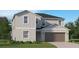 Beautiful two-story home with vertical siding, concrete foundation, and a two car garage at 10248 Purple Leaf Ct, Riverview, FL 33578