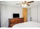 Bedroom with wood dresser and ceiling fan at 10519 Shalimar St, New Port Richey, FL 34654