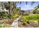 Landscaped backyard pathway leads to a comfortable seating area and views of the home at 108 Rosana Dr, Brandon, FL 33511