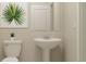 Bathroom with a stylish pedestal sink, toilet, and decorative wall art at 12718 Crystal Jade Way, Parrish, FL 34219