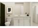 Cozy bathroom featuring a toilet, vanity with sink, and white cabinets with modern hardware at 12718 Crystal Jade Way, Parrish, FL 34219