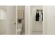A bathroom featuring a toilet and a closet with clothes inside at 12718 Crystal Jade Way, Parrish, FL 34219