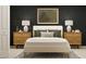 Comfortable bedroom showcasing a bed with nightstands, lamps, decorative pillows, and stylish wall art at 12718 Crystal Jade Way, Parrish, FL 34219