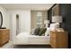 A beautifully staged bedroom with a bed, nightstands, lamps, modern décor, and a view of the closet at 12718 Crystal Jade Way, Parrish, FL 34219