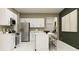 Bright kitchen with white cabinetry, stainless steel appliances, and breakfast bar seating at 12718 Crystal Jade Way, Parrish, FL 34219