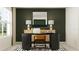 Stylized home office space with dark-colored desk, artwork, and a comfortable chair at 12718 Crystal Jade Way, Parrish, FL 34219