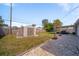 Backyard featuring storage shed, partially graveled area, grassy section, and covered patio at 1489 77Th N Ave, St Petersburg, FL 33702