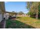 Large backyard with patio seating area and a storage shed enclosed with a wooden fence at 1489 77Th N Ave, St Petersburg, FL 33702