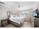 Bright bedroom with a large bed, mirrored headboard, ceiling fan, and plenty of natural light at 1489 77Th N Ave, St Petersburg, FL 33702