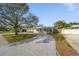 Charming single-story home featuring a spacious driveway and inviting front porch at 1489 77Th N Ave, St Petersburg, FL 33702