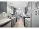 Stylish, modern kitchen with stainless steel appliances and beautiful gray cabinetry at 1489 77Th N Ave, St Petersburg, FL 33702