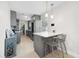 Modern kitchen featuring gray cabinetry, stainless steel appliances, and a breakfast bar at 1489 77Th N Ave, St Petersburg, FL 33702